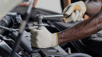 Technician hands working on engine