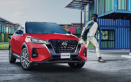 Red Nissan Kicks parked in front of a building